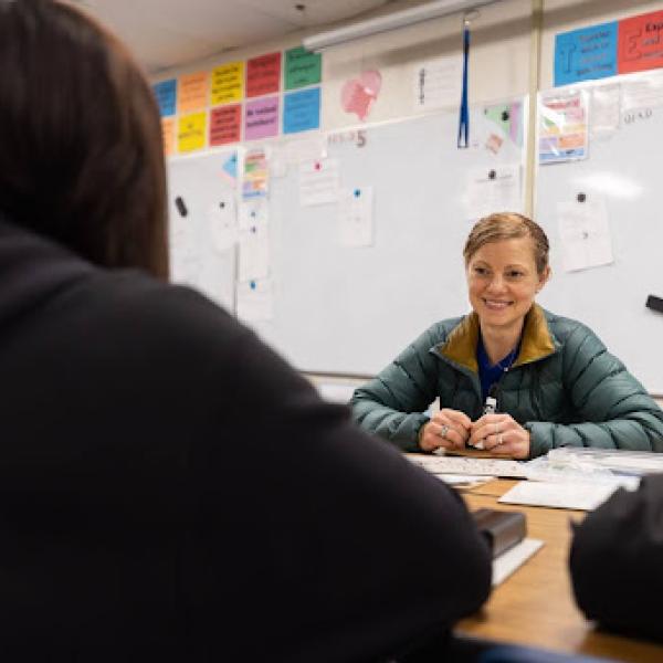Person smiling at camera while talking 